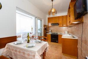 une cuisine avec une table et un chiffon de table blanc dans l'établissement Villa Rosi, à Krk