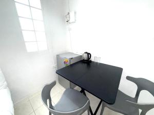 a black table and chairs in a room at Patong Canal Villa R200 in Patong Beach
