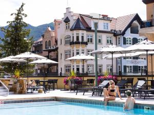 a couple sitting in the pool at a hotel at The Landmark in Vail