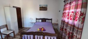 a bedroom with a bed with two slippers on it at Departamento Sol del Valle 02 in Fiambala
