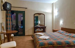 En eller flere senge i et værelse på Hotel Lecadin