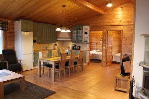 a kitchen and dining room with a table and chairs at Marjakartano Hussola in Karttula