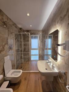 a bathroom with a toilet and a sink and a shower at Blue Harmony in Lalzit Bay