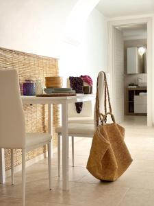 a white dining room table with a purse sitting next to it at Lux Maris by Jdvacanze in Campomarino +80 photos