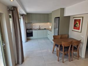 a kitchen and dining room with a table and chairs at Skoza farm house in Nárkissos