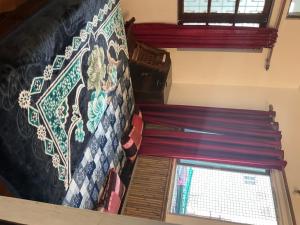 a staircase with a curtain and a window in a room at Happy Shiva Cafe & Homestay in Rishīkesh