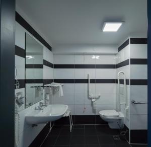 a bathroom with a sink and a toilet at ampm Hotel Schönbrunn in Vienna +65 photos