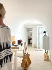 a woman standing in a living room with a table at Lux Maris by Jdvacanze in Campomarino