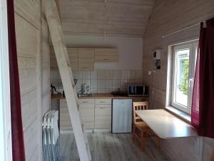 a kitchen with a white refrigerator and a table at Bałtyckie Siedlisko in Jarosławiec