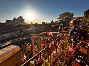 a man standing on a balcony overlooking a city at Residenza Maritti Decò Style- Guesthouse in Rome +95 photos