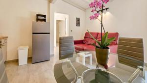 a living room with a glass table and a red couch at Apartment Lux in Novigrad Istria