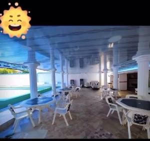 a room with tables and chairs on a cruise ship at Casa Paradise in Carmen de Apicalá