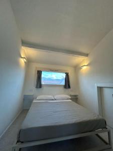 a bedroom with a large bed with a window at Appartamento il Fortino in Forte dei Marmi +26 photos