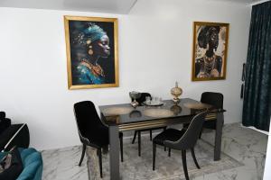 a dining room with a table and a painting on the wall at Luxury Home in Câmpulung