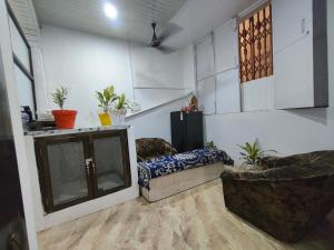 a living room with two chairs and a fireplace at D'Yogi Rooms & Dormitory in Varanasi