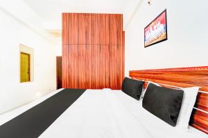Postel nebo postele na pokoji v ubytování Super Hotel O Aarapalayam