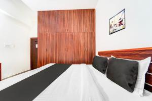 Postel nebo postele na pokoji v ubytování Super Hotel O Aarapalayam