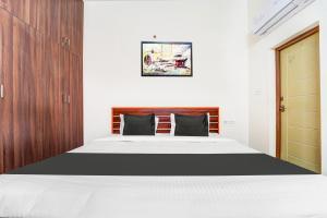 Postel nebo postele na pokoji v ubytování Super Hotel O Aarapalayam