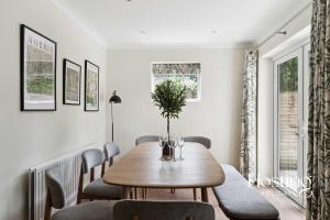 a dining room with a wooden table and chairs at Lavender House - Spacious Henley Home with Parking in Henley on Thames