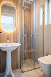 a bathroom with a sink and a shower at El Mar Seaview Penthouse 2 BDR, 7 min from beach in Lagonissi