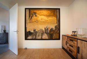 a painting hanging on a wall in a room at NEW! Nightglow Residency in Oosteinde