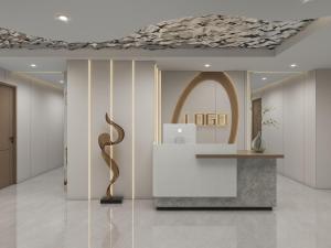 a lobby with a reception desk and a gold sculpture at Queen Palace Hotel in Abu Dhabi