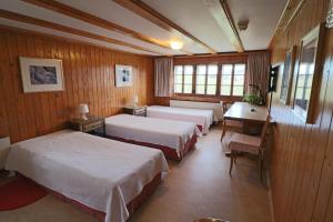 Postel nebo postele na pokoji v ubytování Hotel am Schönenbühl