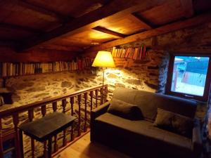a living room with a couch and a balcony at Granja del Peregrino in O Pino 