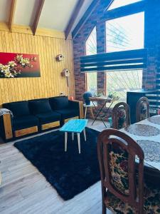 a living room with a couch and a table at Cabañas Alturas Chillan Benjamin in Recinto