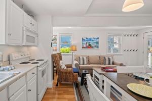 a kitchen and living room with a couch and a table at Private Deck Parking Walk to Town in Provincetown