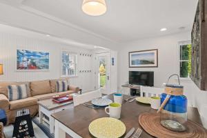 a living room with a couch and a table at Private Deck Parking Walk to Town in Provincetown