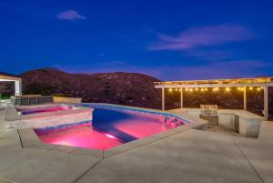 a swimming pool at night with a mountain in the background at Serene Resort-Style Escape - Perfect for Families in El Cajon