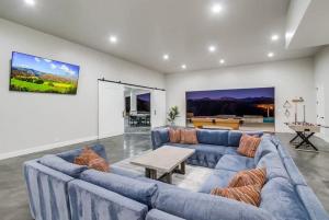 a living room with a blue couch and a table at Serene Resort-Style Escape - Perfect for Families in El Cajon