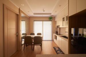 a kitchen and dining room with a table and chairs at Là Nhà - Homestay Hạ Long in Ha Long