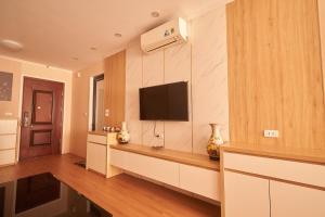a living room with a flat screen tv on a wall at Là Nhà - Homestay Hạ Long in Ha Long