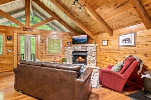 a living room with a couch and a fireplace at Mountain Dream By Avada Properties in Sevierville