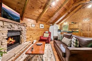 a living room with a couch and a fireplace at Mountain Dream By Avada Properties in Sevierville
