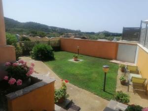 a small backyard with a yard of grass and flowers at Chia View Pool, AC, Garden Relaxation in Chia +2 photos