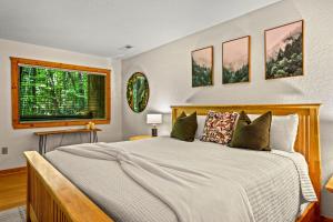 a bedroom with a large bed and a window at Mountain Dream By Avada Properties in Sevierville