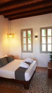 a bedroom with two beds and two windows at Lagadi House 2 in Arnados
