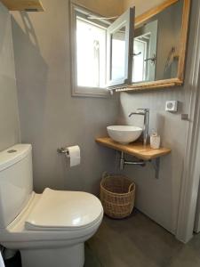 a bathroom with a white toilet and a sink at Lagadi House 2 in Arnados