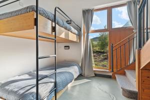 a bedroom with bunk beds and a window at Errigal Hostel in Gweedore