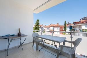 a patio with a table and chairs on a balcony at A spacious, comfortable and cozy apartment close to the center of Fethiye in Fethiye