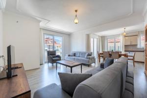 a living room with a couch and a table at A spacious, comfortable and cozy apartment close to the center of Fethiye in Fethiye