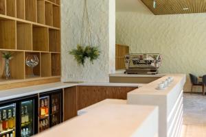 a bar in a restaurant with a counter with bottles of wine at Studio South - VOGH in Olimp