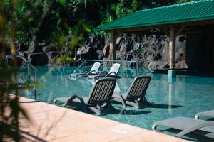 a row of chairs in a swimming pool at Iguazu Jungle Lodge in Puerto Iguazú