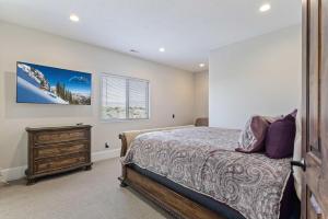 a bedroom with a bed and a dresser at Majesty Estate in Salt Lake with Private Pool and Sport Court in Draper +71 photos