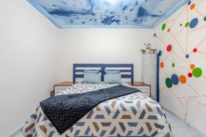 a bedroom with a bed in a room with a ceiling at Monoshez in Benoni +5 photos