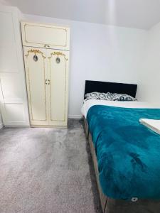 a bedroom with a bed and a yellow cabinet at Private Room in Glasgow City in Hillfoot