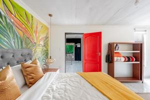 a bedroom with a bed with a red door at Monoshez in Benoni